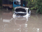 Припаркованная у обочины иномарка «утонула» на дороге после проливного дождя в Ростове